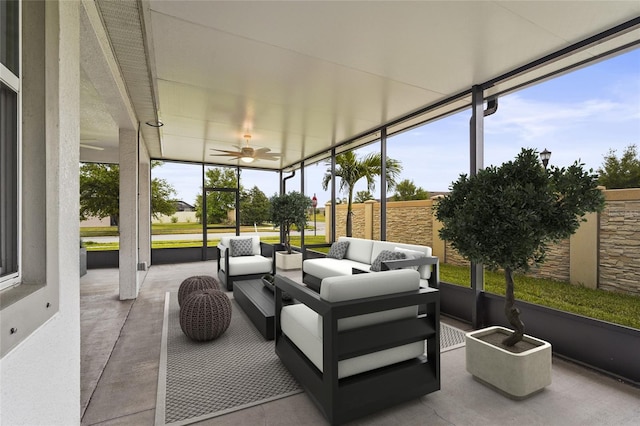 sunroom featuring an outdoor living space and a ceiling fan