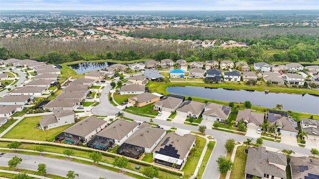 drone / aerial view with a water view and a residential view