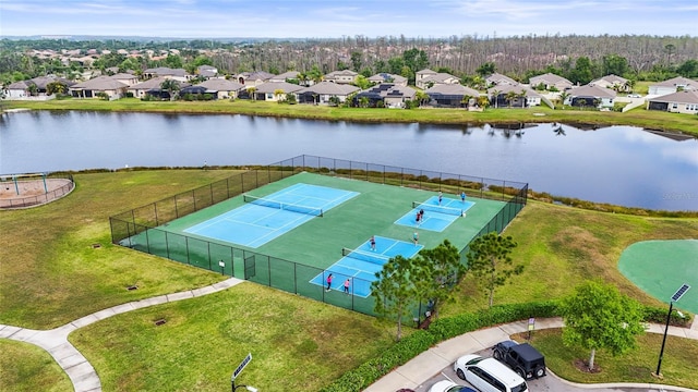 drone / aerial view featuring a water view and a residential view