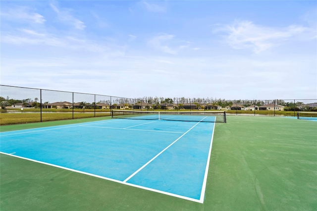 view of sport court featuring fence
