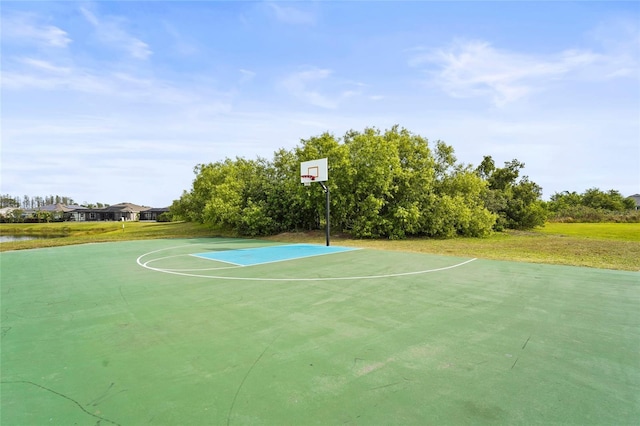 view of basketball court with community basketball court and a yard
