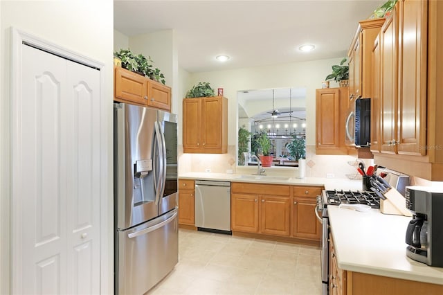 kitchen featuring tasteful backsplash, light countertops, recessed lighting, appliances with stainless steel finishes, and a sink