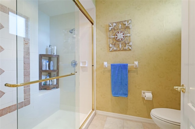 bathroom featuring tile patterned floors, baseboards, toilet, and a stall shower