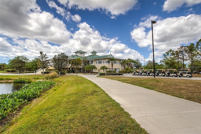 exterior space with a water view and a lawn