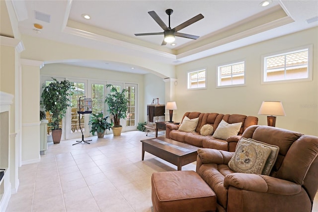 living room with plenty of natural light and a tray ceiling