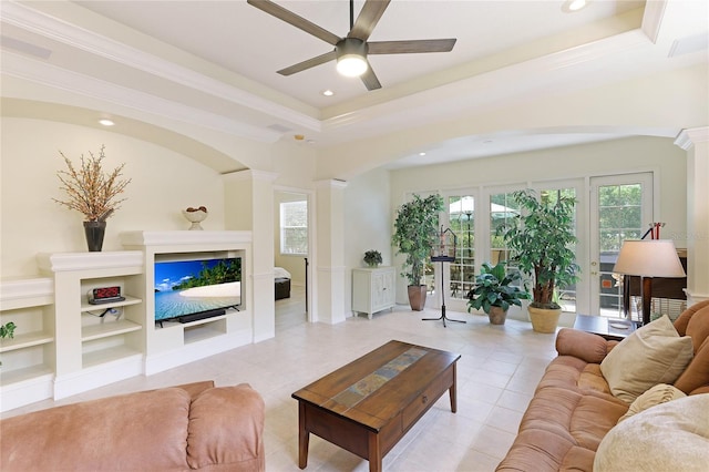 living area with light tile patterned flooring, recessed lighting, ceiling fan, ornamental molding, and a raised ceiling