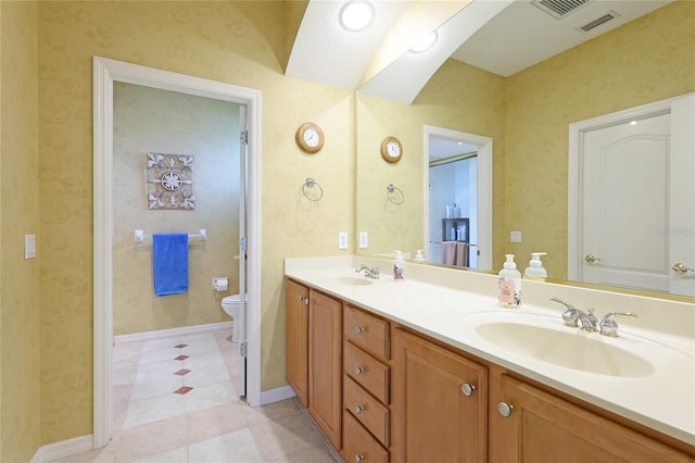 full bath with double vanity, toilet, visible vents, and a sink