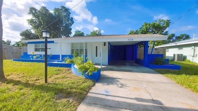 view of front facade featuring central AC unit, an attached carport, fence, concrete driveway, and a front lawn