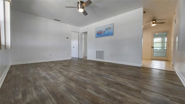 unfurnished room with a ceiling fan, baseboards, visible vents, and wood finished floors