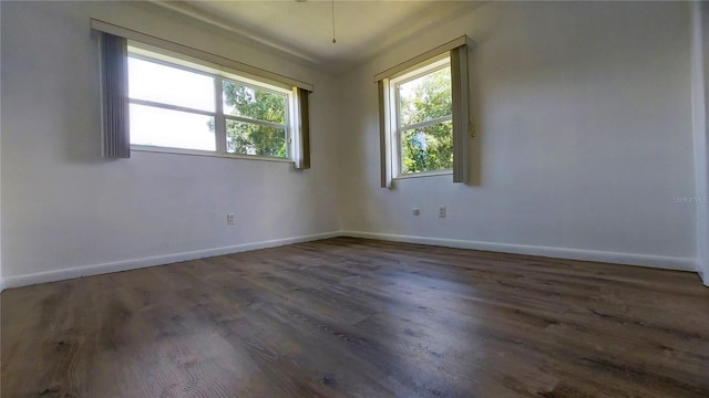 empty room with baseboards and wood finished floors