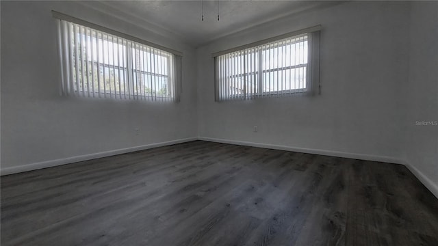 unfurnished room featuring wood finished floors and baseboards