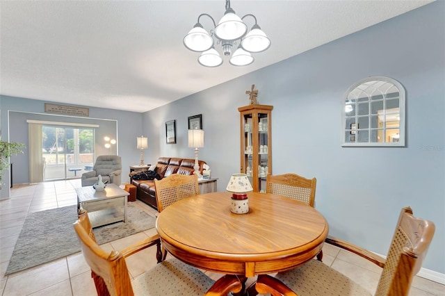 dining room with baseboards, a notable chandelier, and light tile patterned flooring