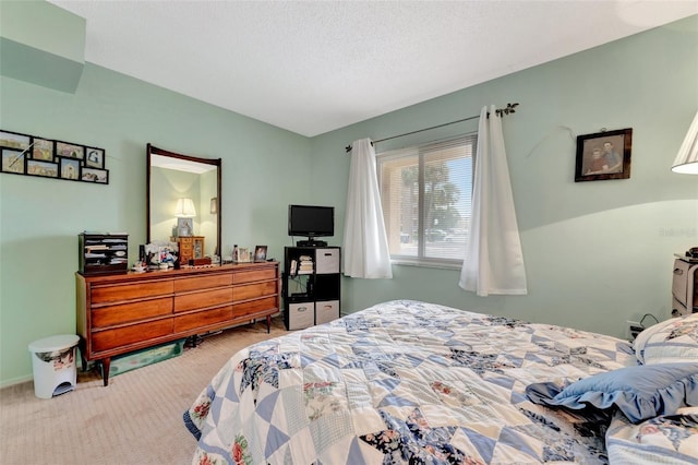 carpeted bedroom featuring a textured ceiling