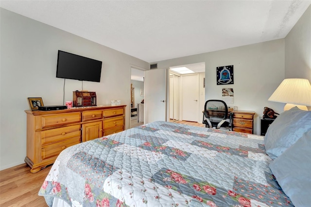 bedroom featuring visible vents and light wood-style flooring