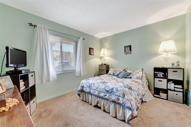 carpeted bedroom featuring baseboards and a textured ceiling