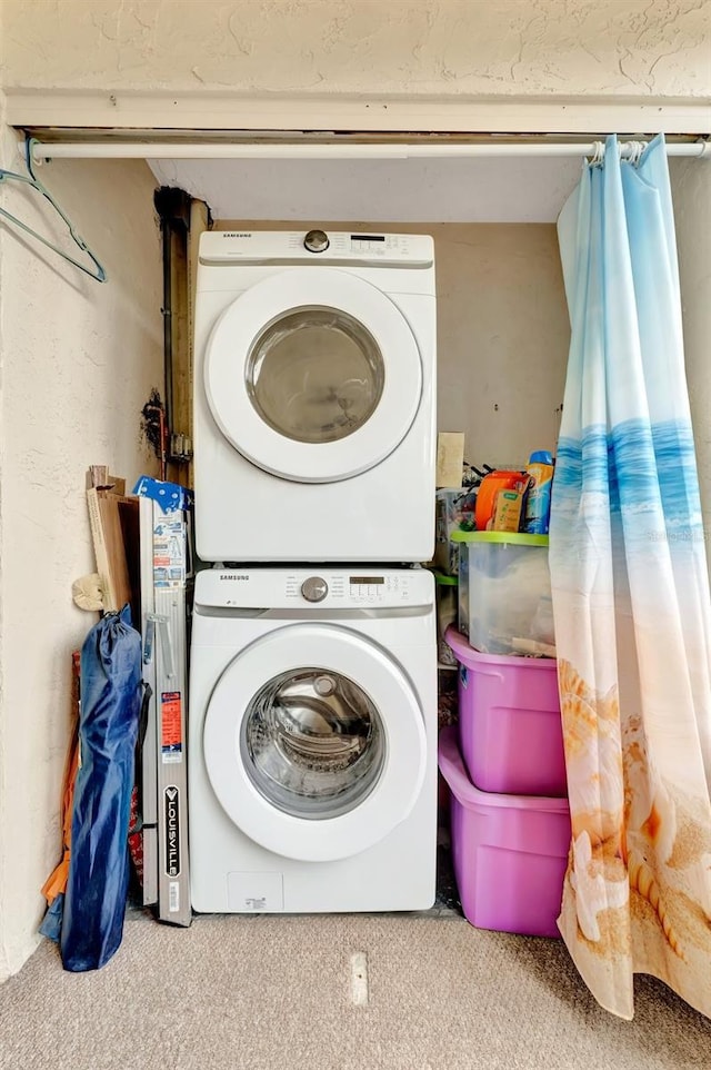 laundry area featuring stacked washing maching and dryer