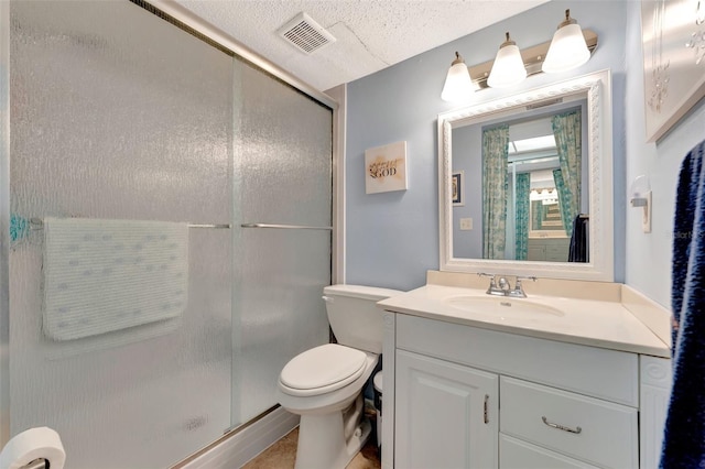 bathroom featuring a stall shower, visible vents, toilet, a textured ceiling, and vanity