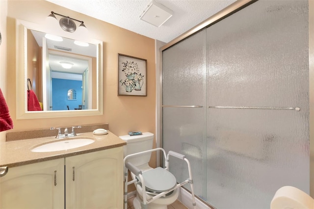 full bathroom with a textured ceiling, toilet, visible vents, vanity, and a stall shower