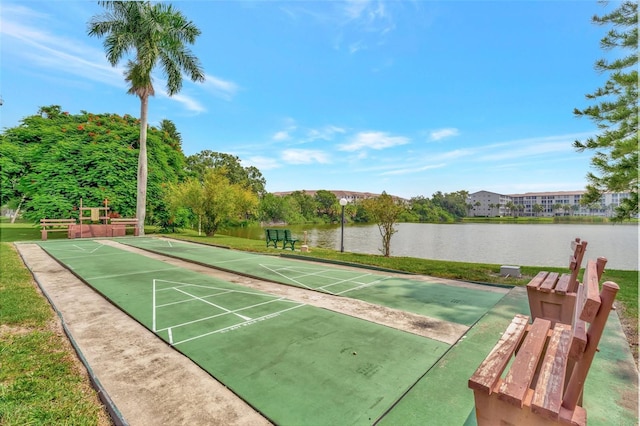 view of community featuring a water view, shuffleboard, and a yard