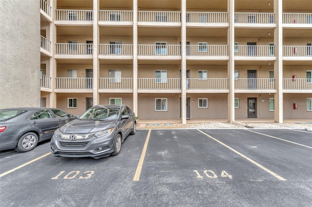 view of property featuring uncovered parking