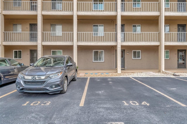 view of property with uncovered parking