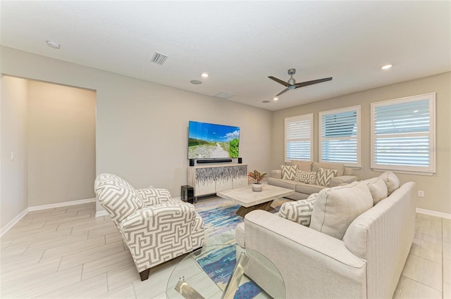 living area with recessed lighting, visible vents, baseboards, and ceiling fan