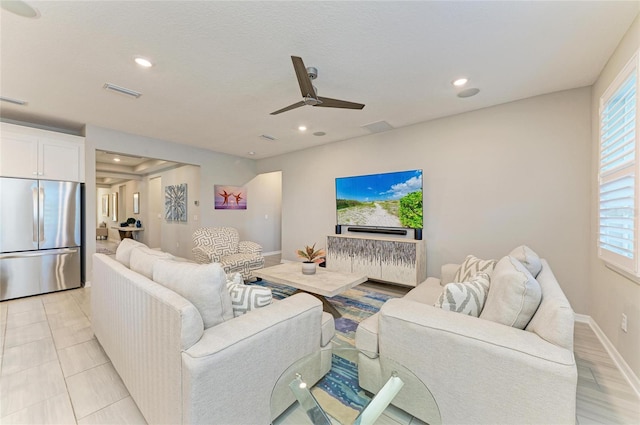 living area featuring ceiling fan, recessed lighting, visible vents, and baseboards