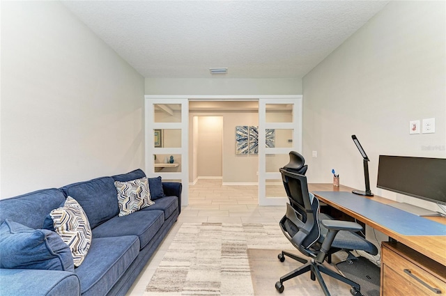 office featuring baseboards, french doors, visible vents, and a textured ceiling