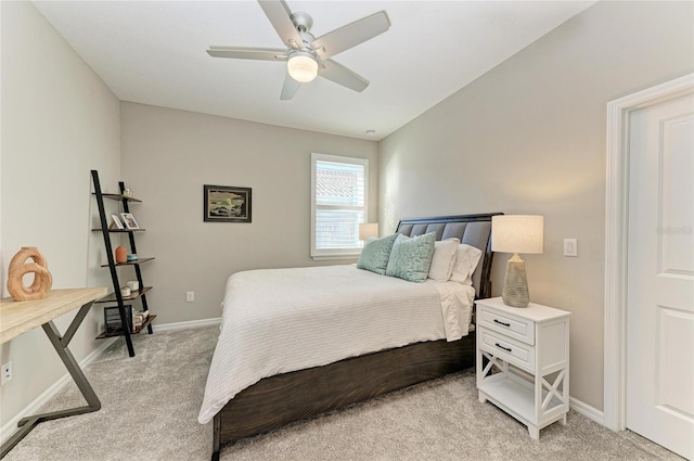 bedroom with light colored carpet, baseboards, and ceiling fan