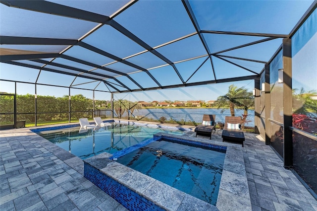 view of swimming pool featuring glass enclosure, a patio, a water view, and a pool with connected hot tub