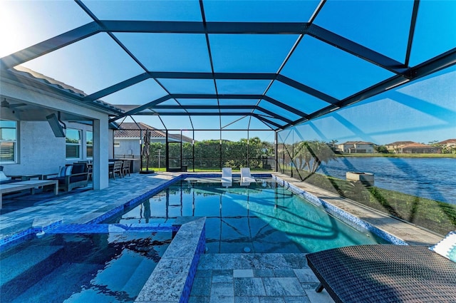 pool featuring glass enclosure, a water view, and a patio area