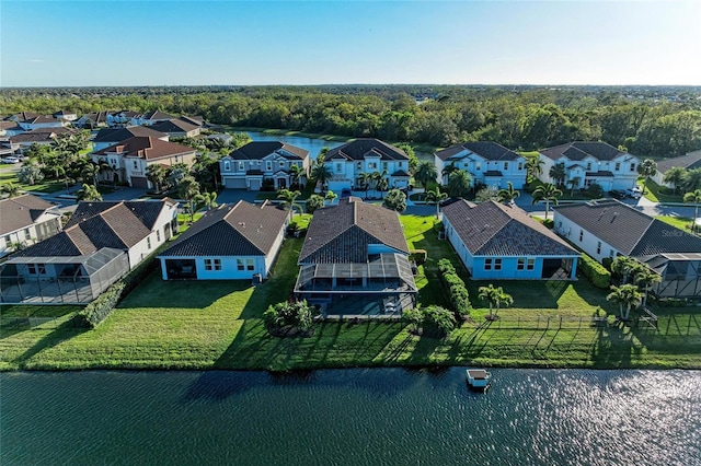 drone / aerial view featuring a residential view and a water view