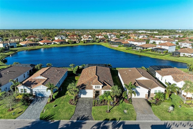 drone / aerial view with a residential view and a water view