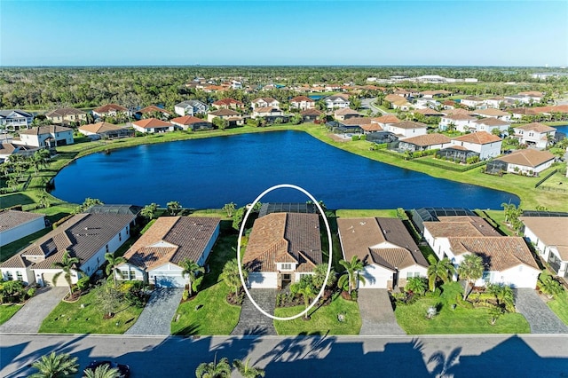 drone / aerial view featuring a residential view and a water view