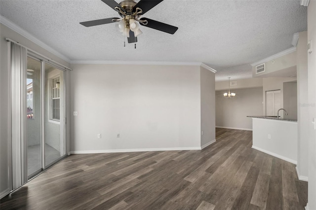 spare room with ornamental molding, dark wood finished floors, visible vents, and baseboards