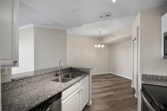 kitchen featuring dark stone counters, visible vents, a sink, and a textured ceiling