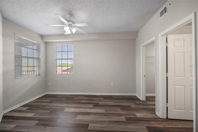 spare room featuring visible vents, baseboards, and wood finished floors