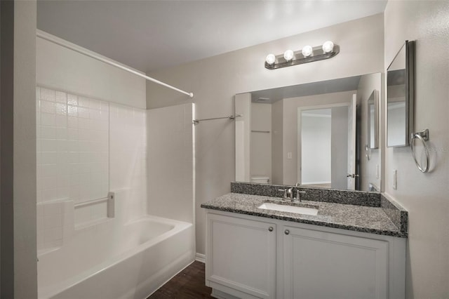 bathroom featuring toilet,  shower combination, and vanity