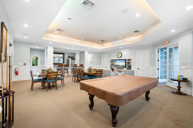 playroom with light colored carpet, a tray ceiling, and visible vents