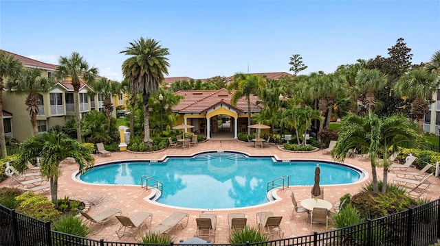 pool featuring a patio area and fence