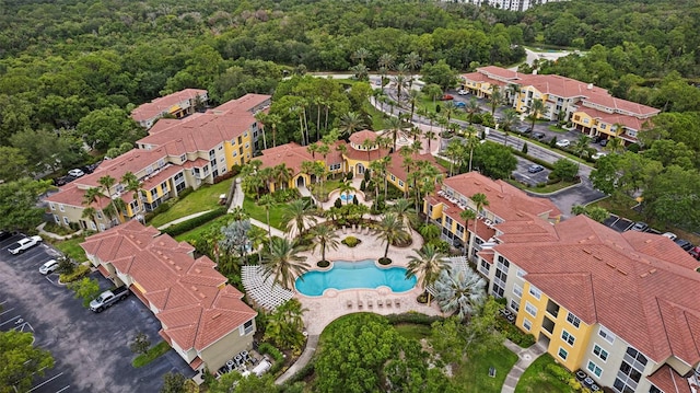 birds eye view of property with a residential view and a view of trees