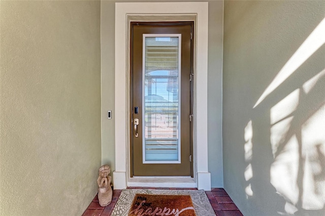 entrance to property with stucco siding