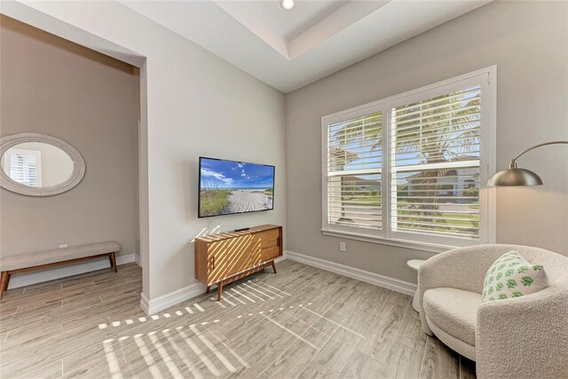 living area featuring light wood-style floors and baseboards