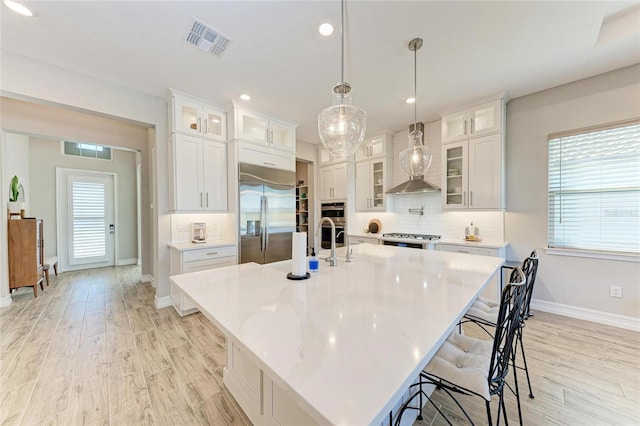 kitchen featuring tasteful backsplash, visible vents, stainless steel appliances, and a wealth of natural light