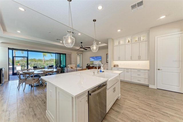 kitchen featuring dishwasher, open floor plan, a raised ceiling, and visible vents