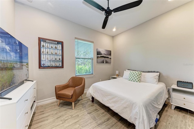 bedroom with baseboards, recessed lighting, a ceiling fan, and light wood-style floors