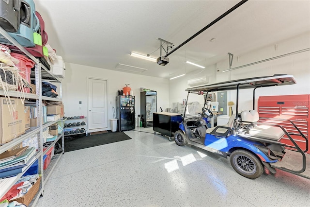 garage with a garage door opener and freestanding refrigerator