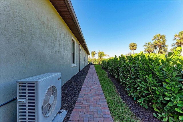 view of property exterior featuring ac unit, fence, and stucco siding