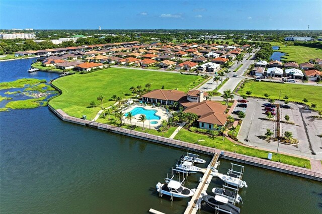 drone / aerial view featuring a residential view and a water view