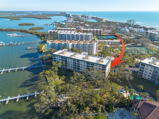 drone / aerial view featuring a city view and a water view